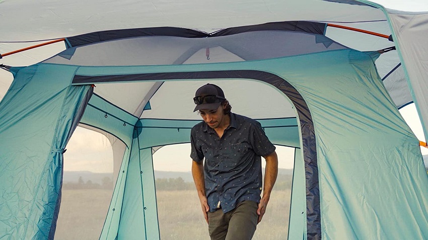A man stands inside the Eureka Jade Canyon X4 Person Tent