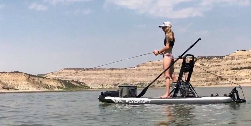A lady fishes from the Flycraft Mountain SUP