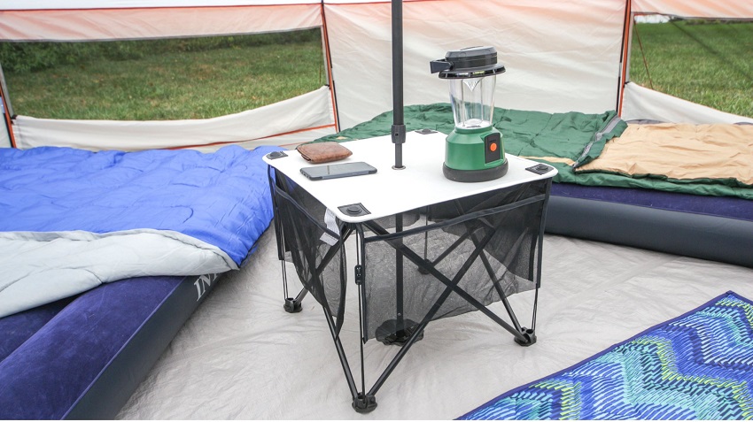 A collapsible table with a lantern on it in the center of Ozark Trail 8 Person Yurt Camping Tent