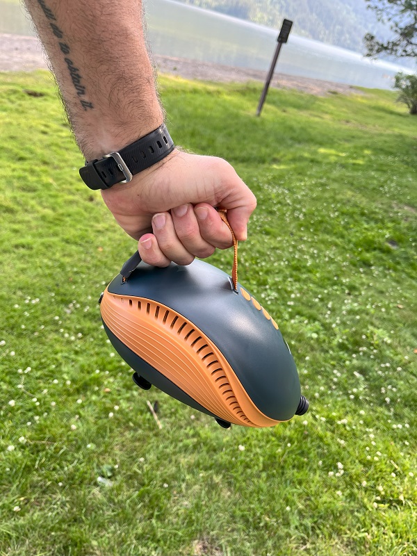 OutdoorMaster Dolphin SUP Pump is held by a human hand