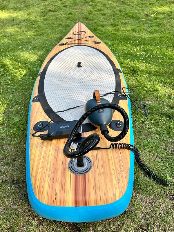 OutdoorMaster Dolphin SUP pump is connected to a paddle board
