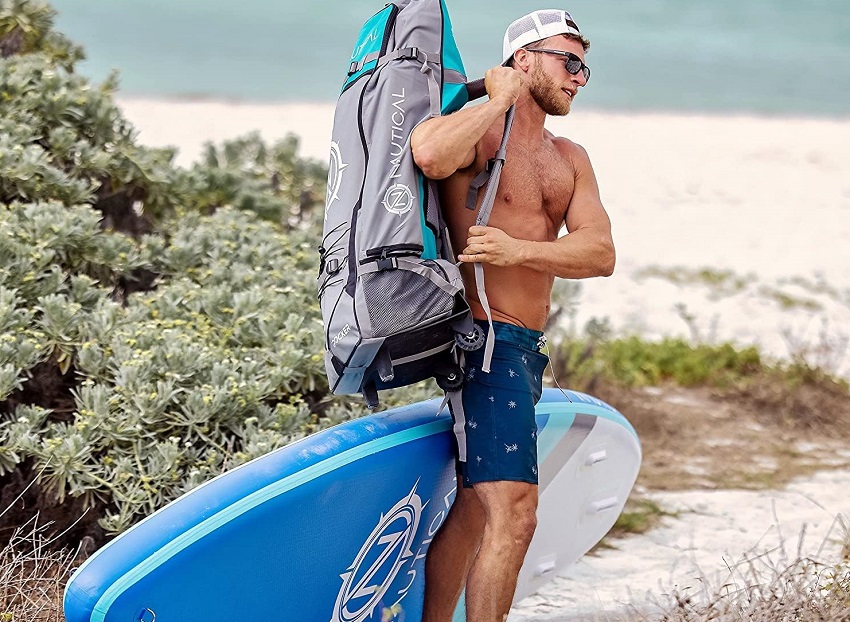 A man slings a bag with the packed Nautical paddle board