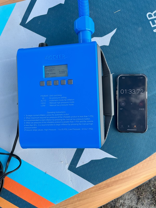 A smartphone lies near the iRocker Electric Pump and measures inflation time